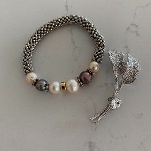 Elastic silver colored bracelet w/ rhinestone pin